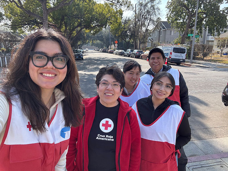 Francis Huezo smiles for picture with four other Red Cross volunteers.