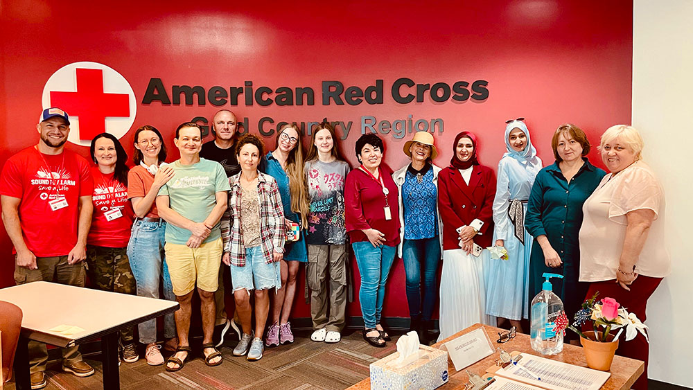 Group pic of the members of the Russian-speaking volunteer team inside a Red Cross building.