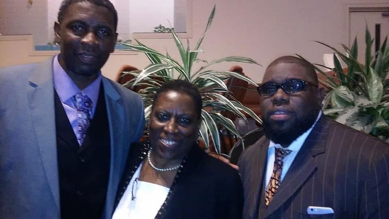 Dr. La Vetta Coleman and her two sons wearing church clothing.