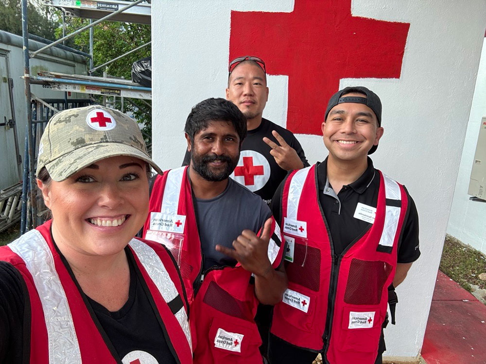 Caedy Minoletti and three Red Cross volunteers smiling for picture.