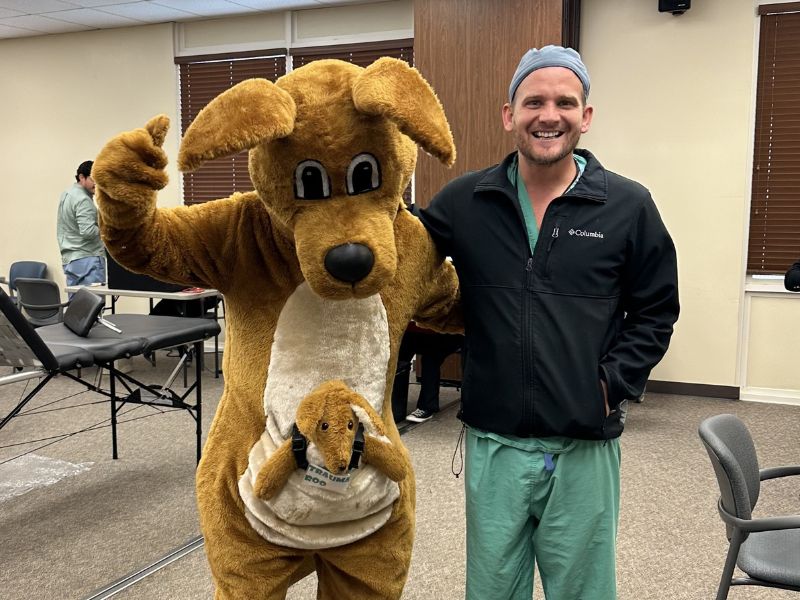 doctor posing with mascot