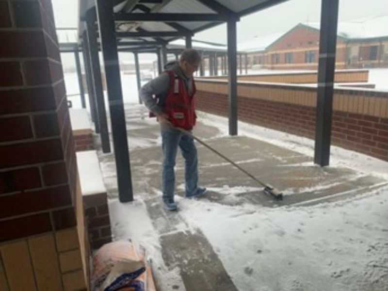 gary thurman shoveling snow from sidewalk