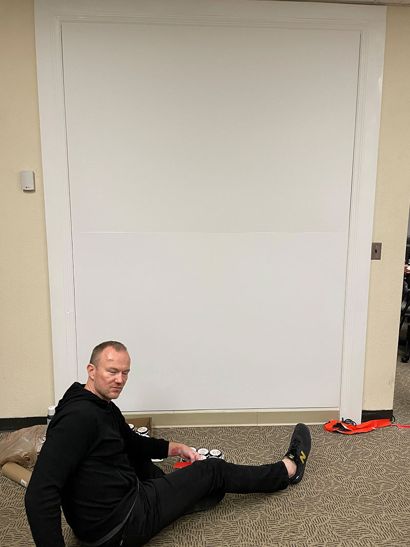 Person preparing to paint a mural.