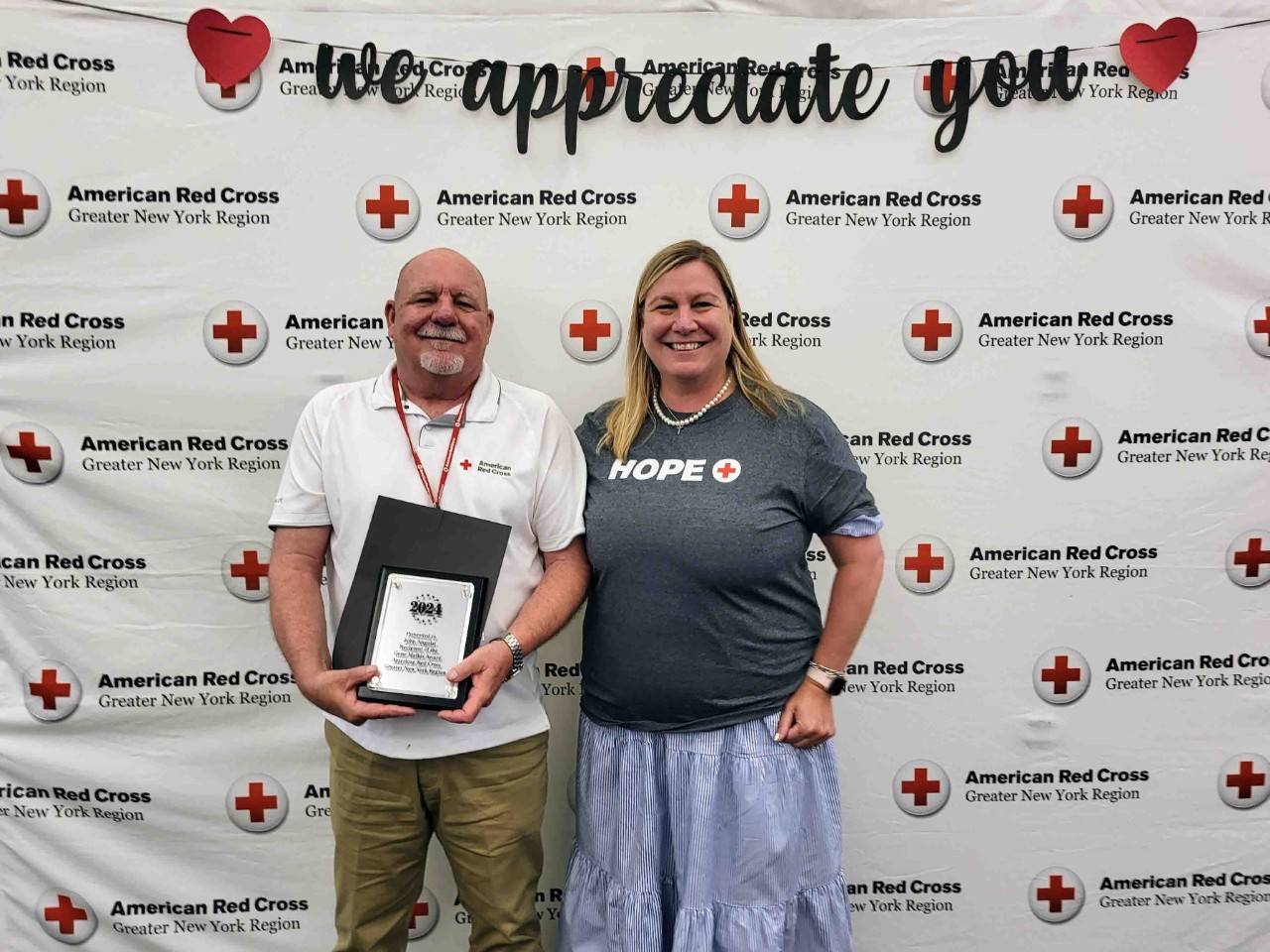 Stephanie Dunn-Ashley poses with award winner John Angulat