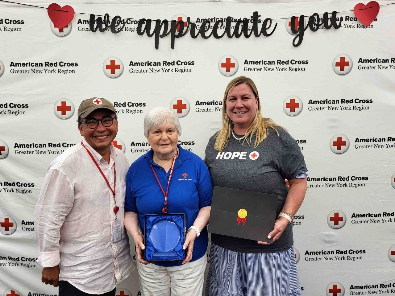 Jose Dominguez and Stephanie Dunn-Ashley pose with award winner Joy Weaver