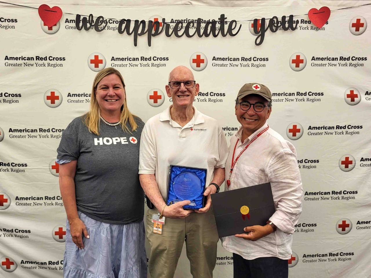 Stephanie Dunn-Ashley and Jose Dominguez pose with award winner Phil Cogan.