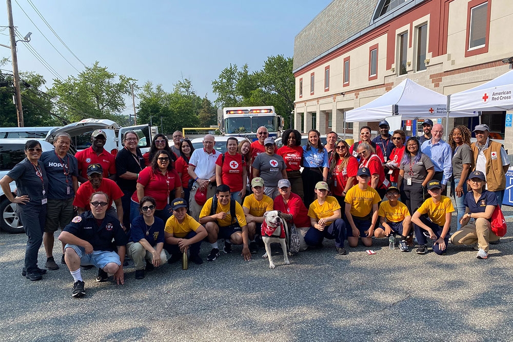 Group photo of Red Cross volunteers and firefighters