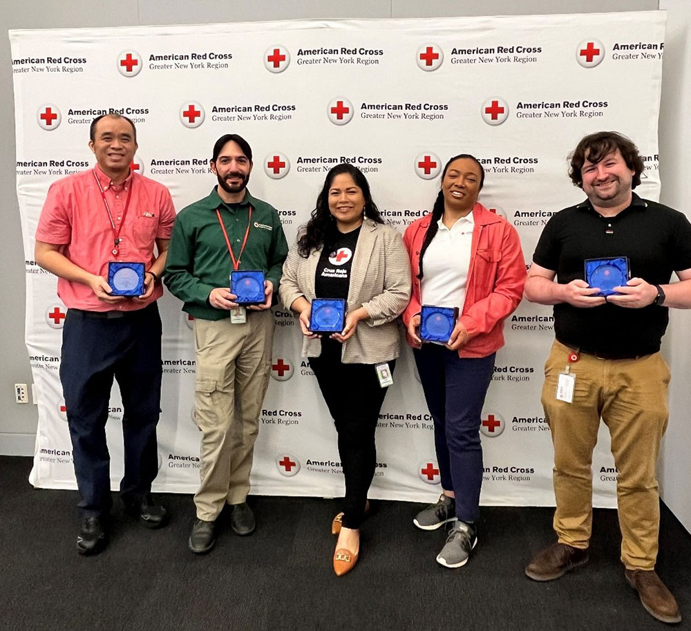 group photo of the 2025 5C Award honorees holding their awards.