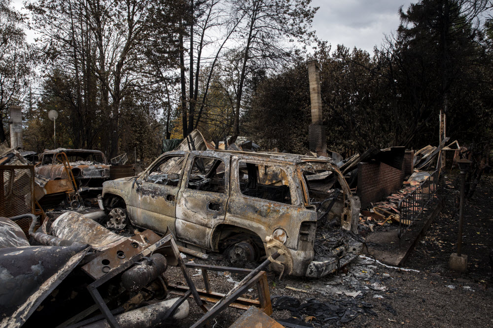 A burned down home and a burned out SUV.