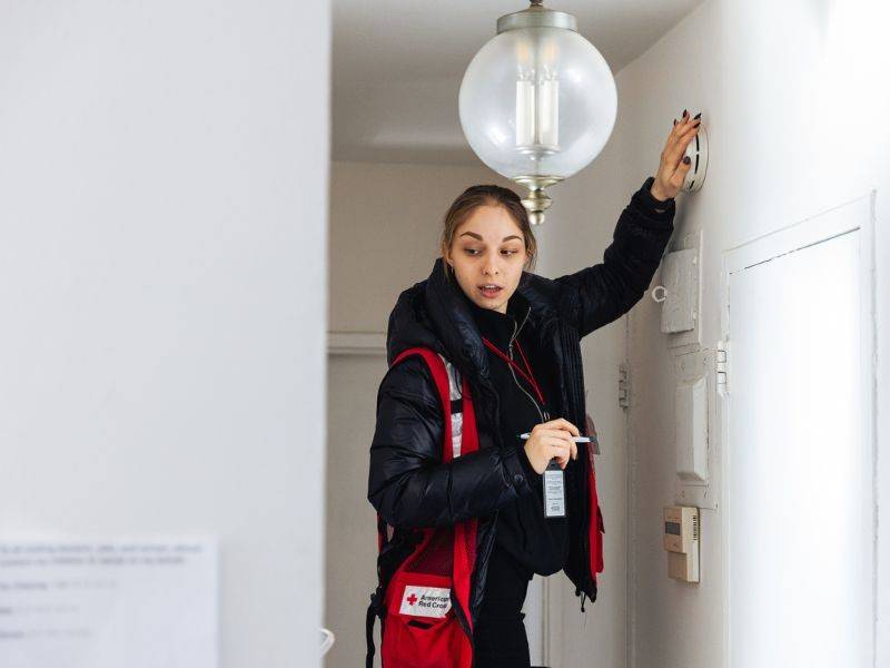 Alina Shevtsova testing smoke alarm