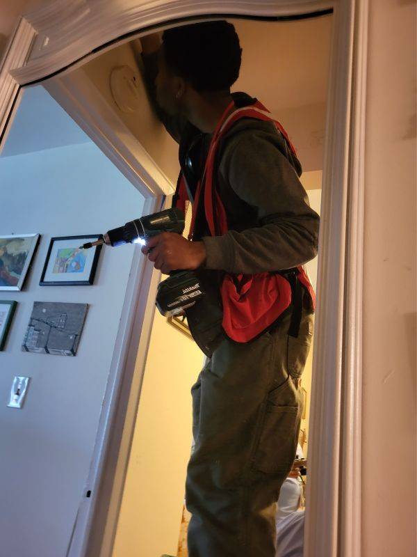 red cross volunteer installing alarm