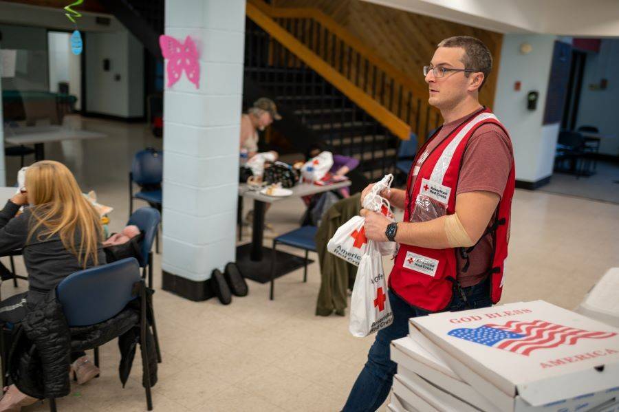 At a temporary Red Cross reception center in Yonkers, Red Cross volunteer Daniel Roberts distributes personal hygiene supplies to residents forced to leave their apartment building after it was severely damaged by fire.