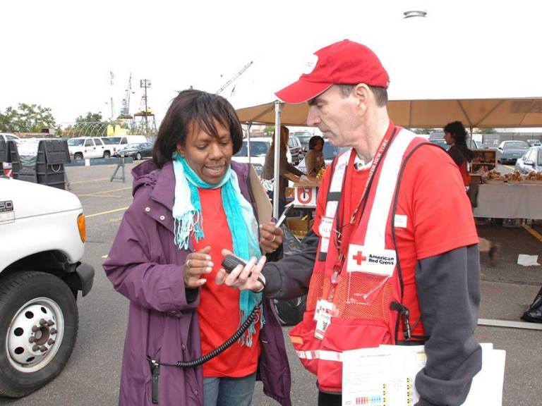 Richard Gallis showing a fellow Red Cross volunteer how to use the radio at a disaster simulation event in 2009.