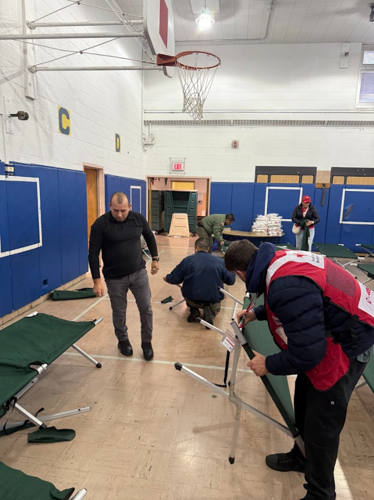  Red Cross responders set up cots to open a shelter at the former Holmes Elementary School in Mount Vernon to support residents displaced by the Cottage Avenue fire.