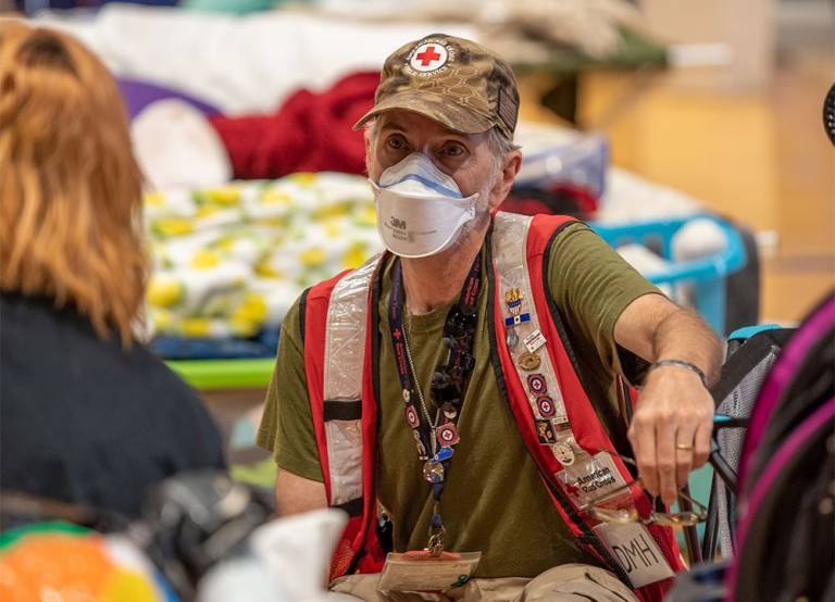 Red Cross volunteer speaking to woman