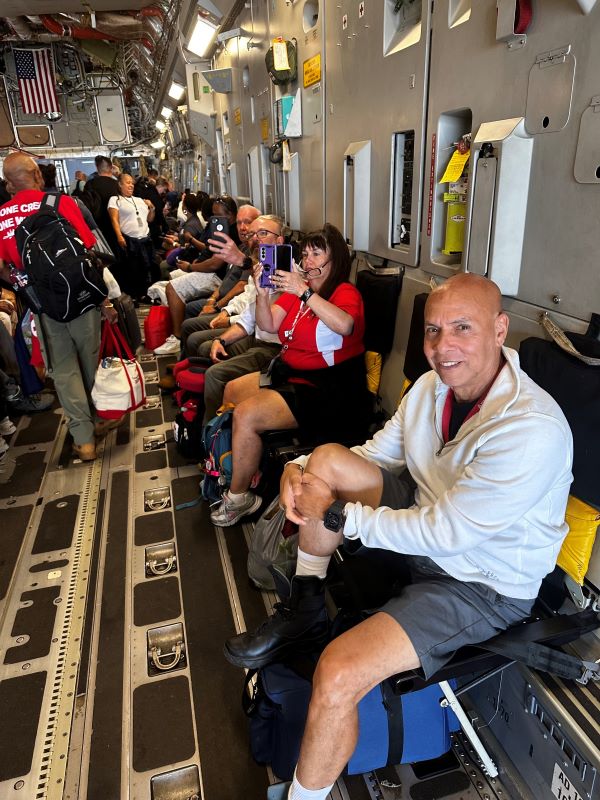 A group of people sitting in a cargo plane