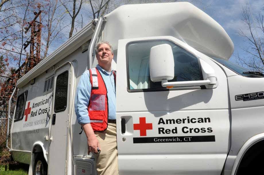 volunteer stepping out of red cross vehicle