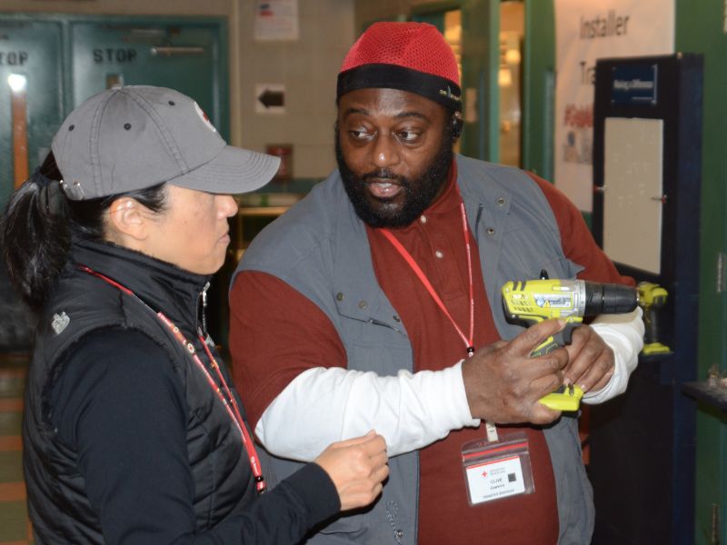 volunteer holding power drill