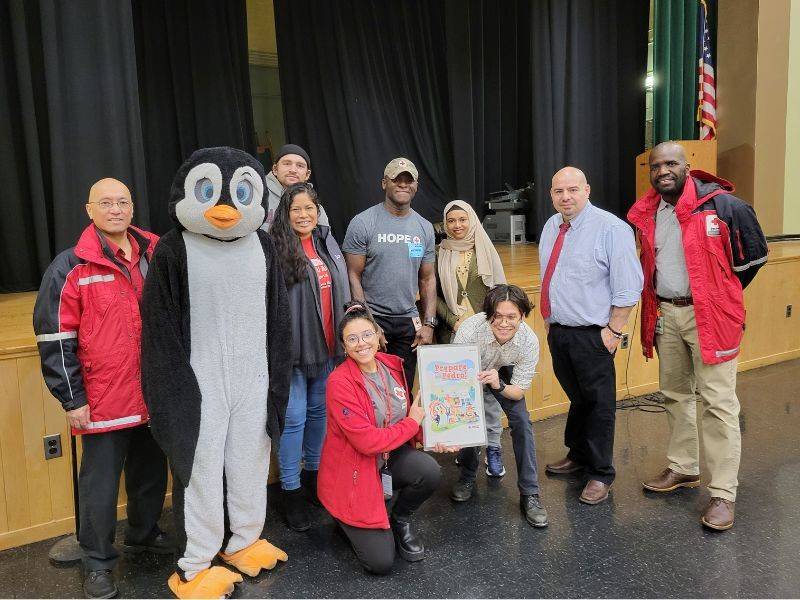 Red Cross presenters pose with Pedro