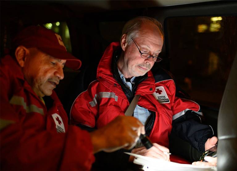 Red Cross volunteers looking at plans