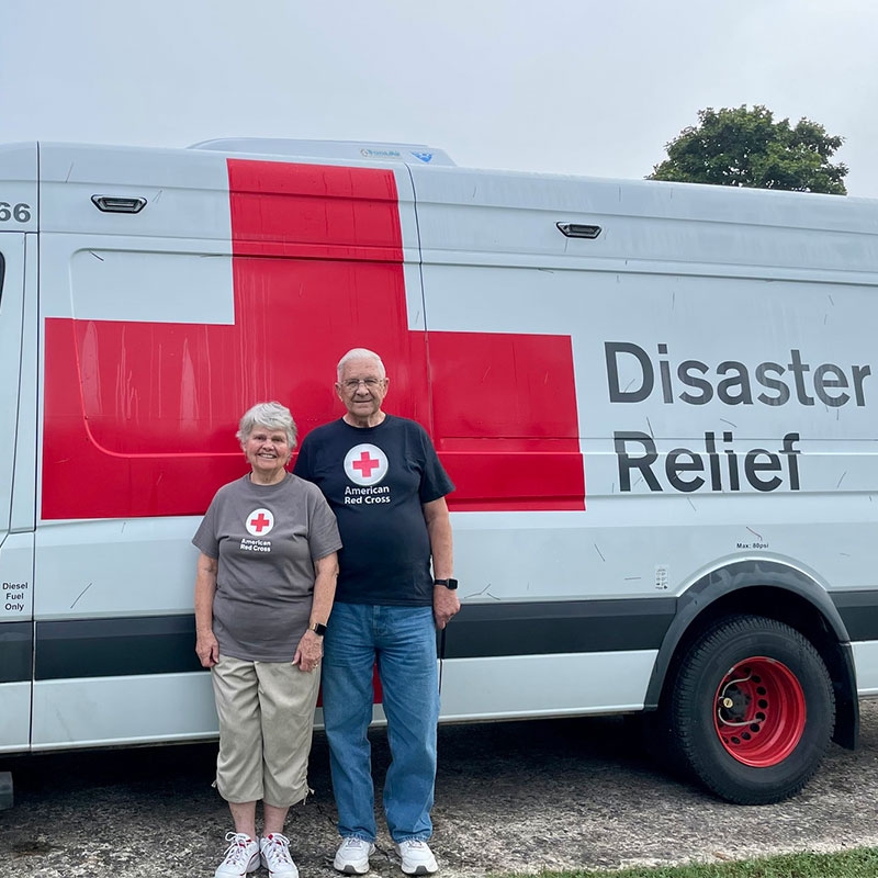 Monica and John Fill next to Red Cross van
