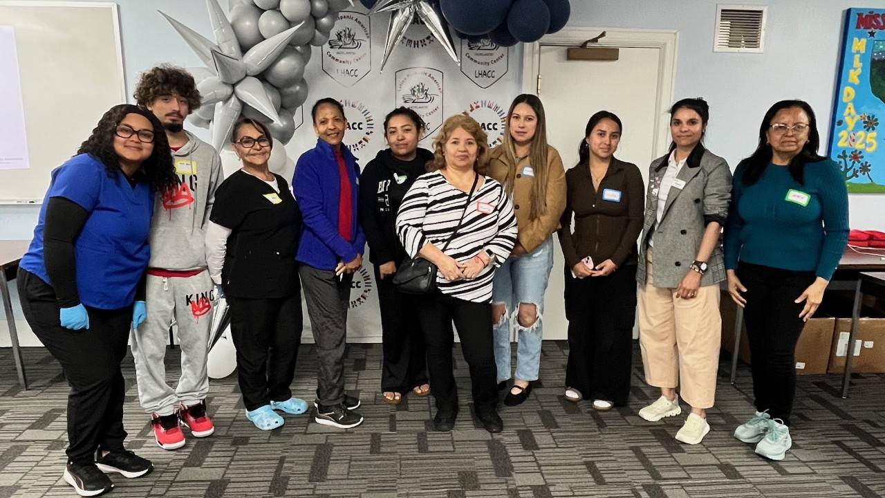 A group poses in front of LHACC backdrop.