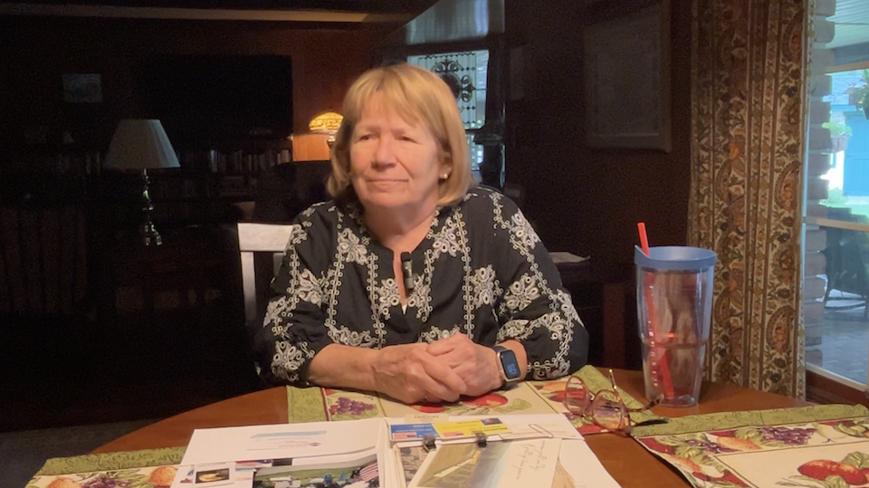 Patti Anewalt sitting at a kitchen table.