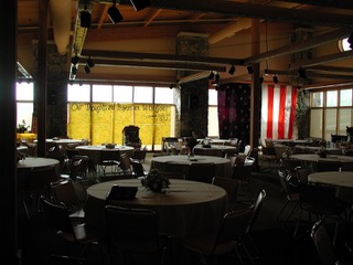 Family Assistance Center with tables and chairs. Banners cover the windows and an American Flag is hung on the right side