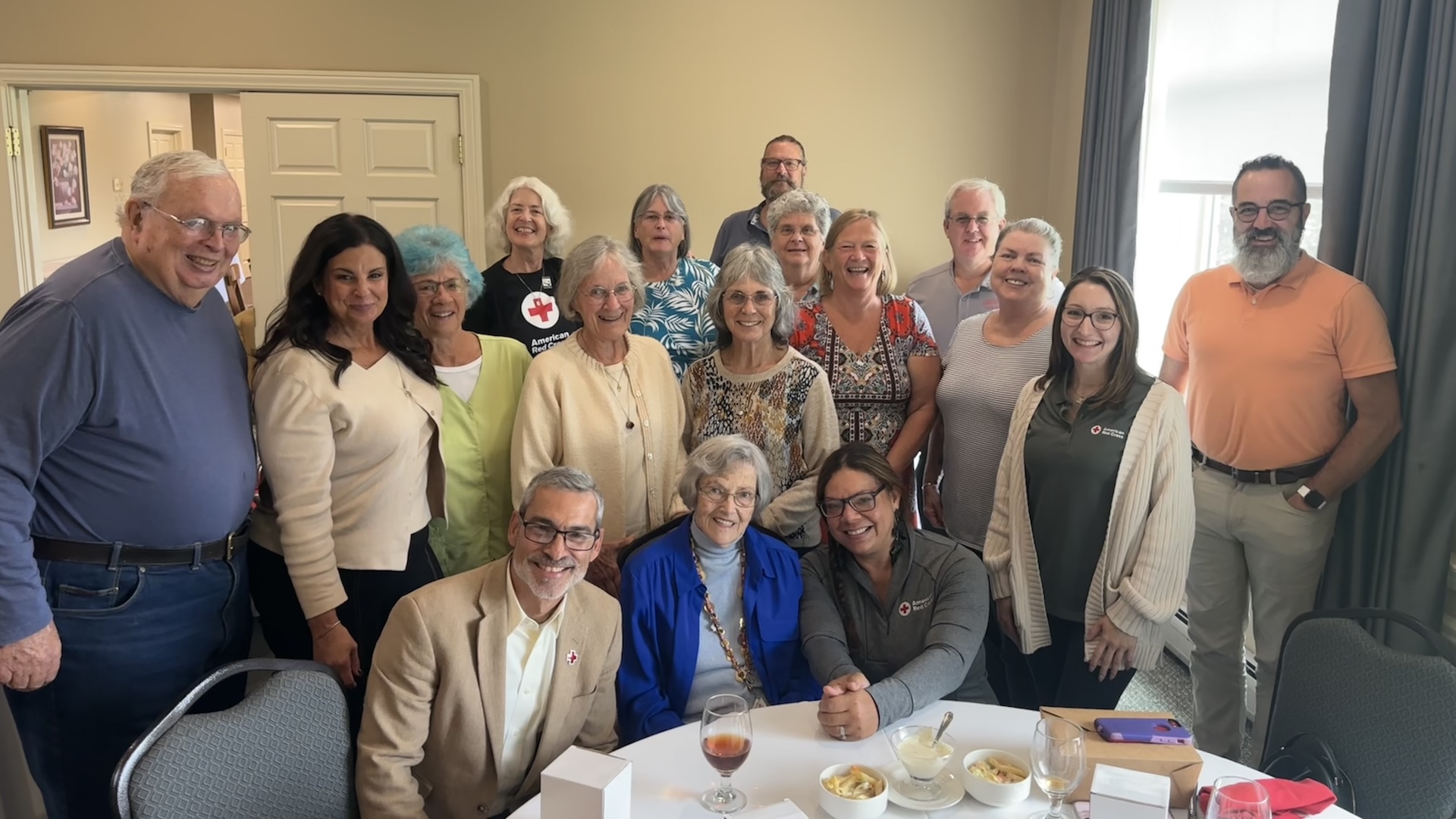 Getty Stewart, center, surrounded by Red Cross staff and volunteers at a recognition event.