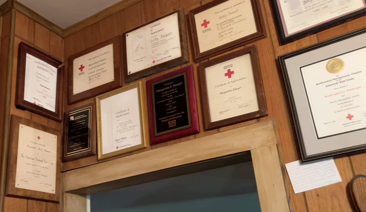 Red Cross awards line the walls of Getty Stewart's home, marking 70 years of dedicated service