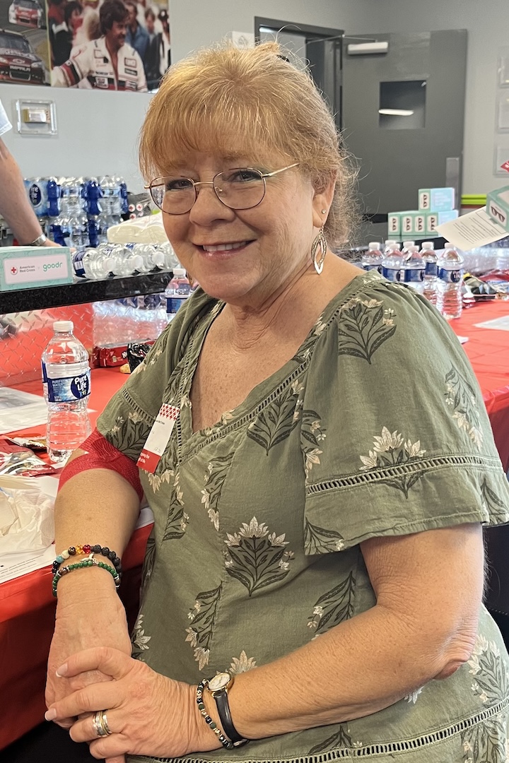 Diane Marschall smiles while sitting at the snack table after her blood donation.