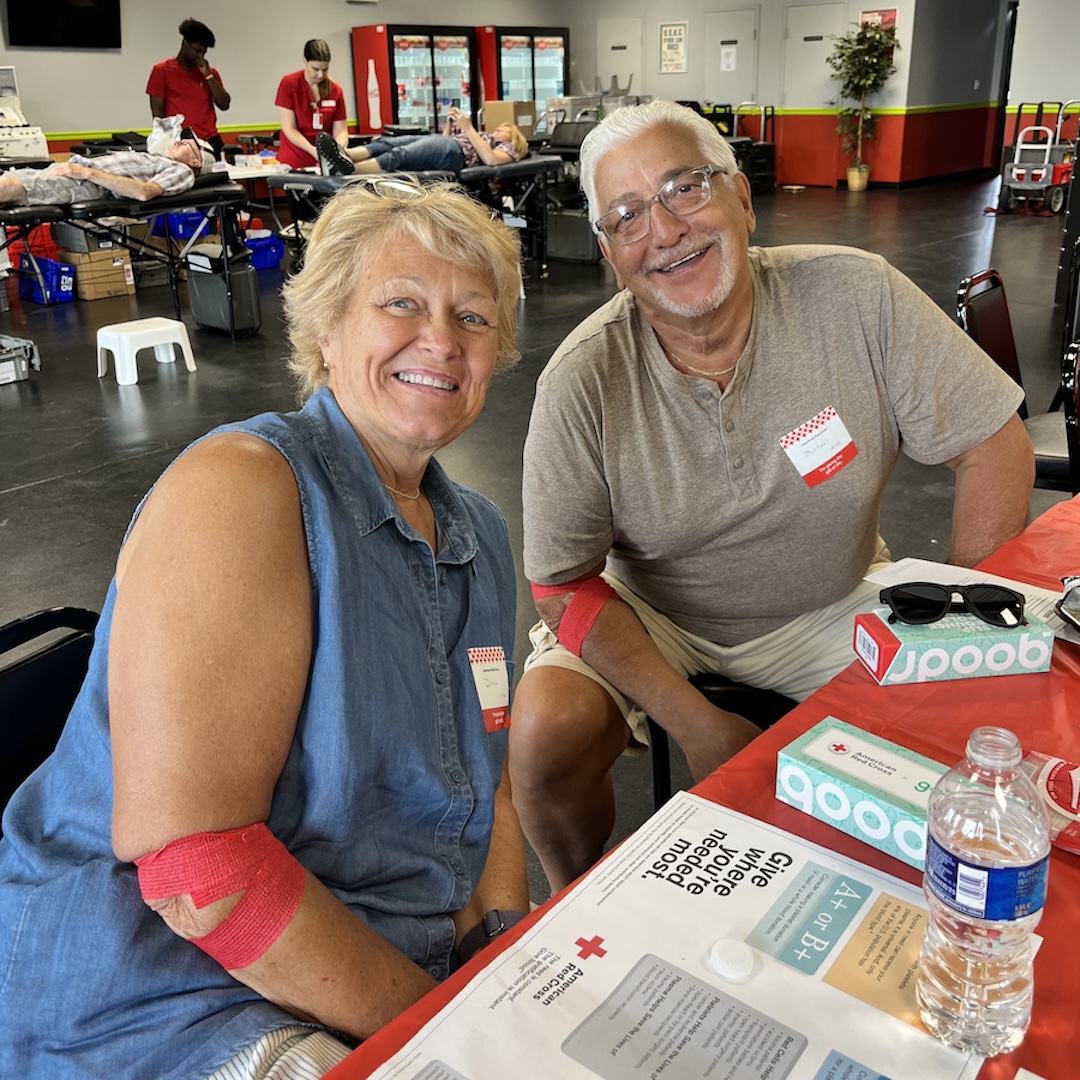 Donna and Michael Doridio smiling at the snack table after donating blood.