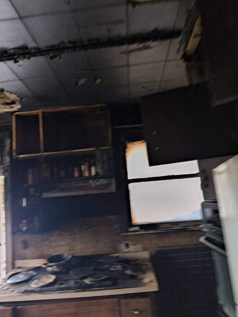 Image of charred kitchen after home fire.