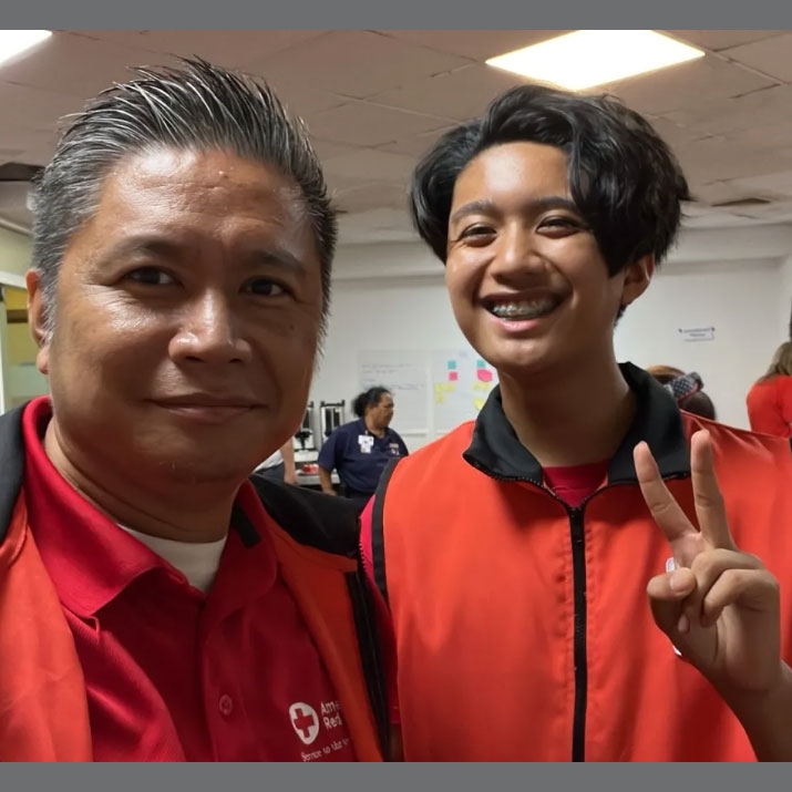 Red Cross volunteers smile for camera.