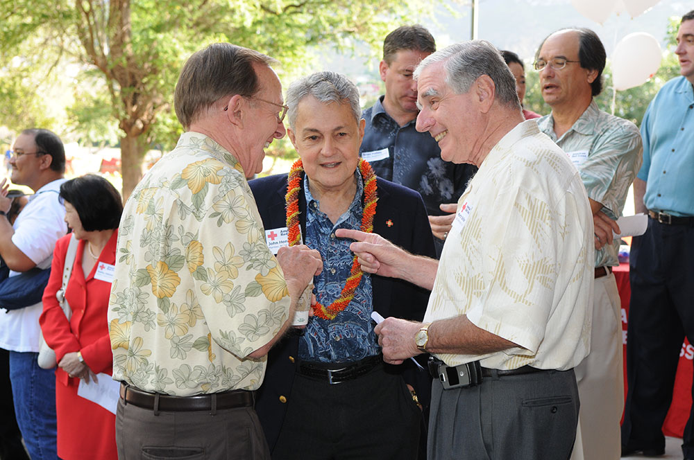 Dr. John Henry Felix outside speaking with Red Cross employees.