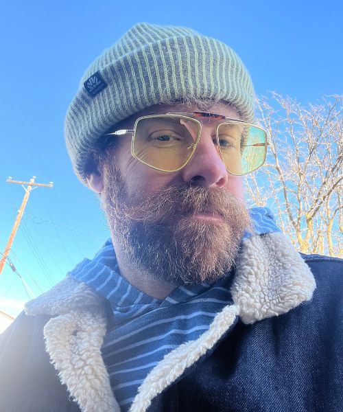 zach sherman with beanie and jacket on outside.