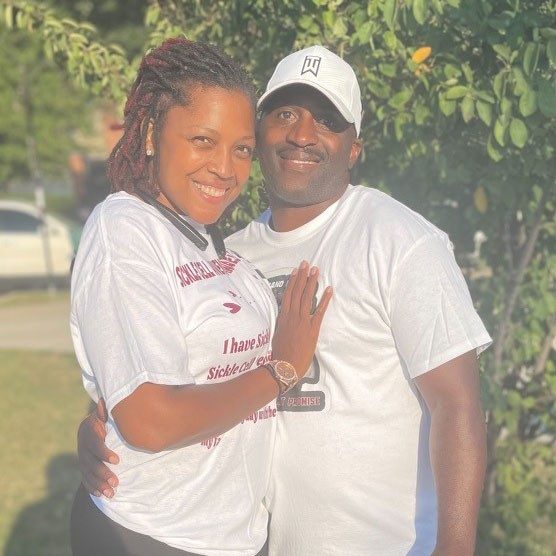 Denesha Carter Mitchell and husband smiling for camera