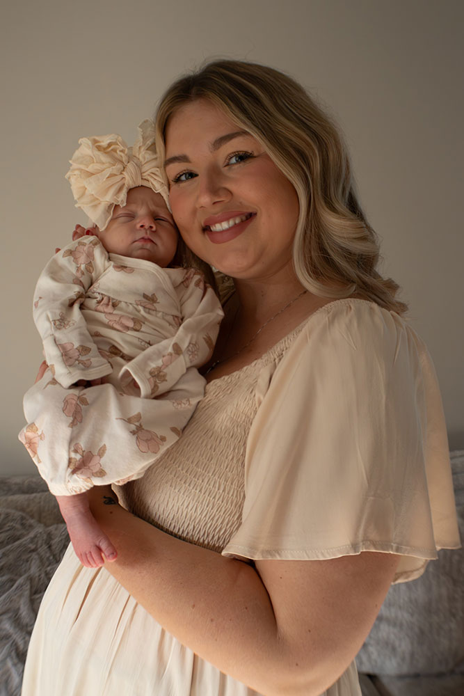 Tessa Troike-Barnett holding her new born daughter, Dani.