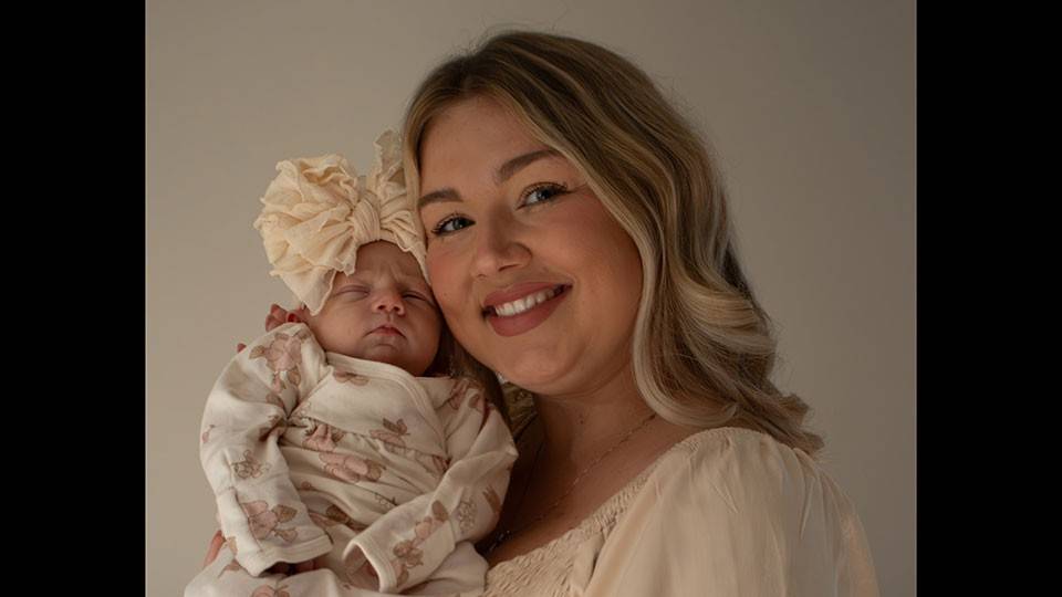 Tessa Troike-Barnett holding her new born daughter, Dani.