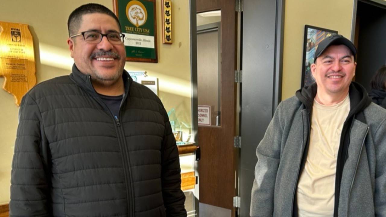 two men smiling in office