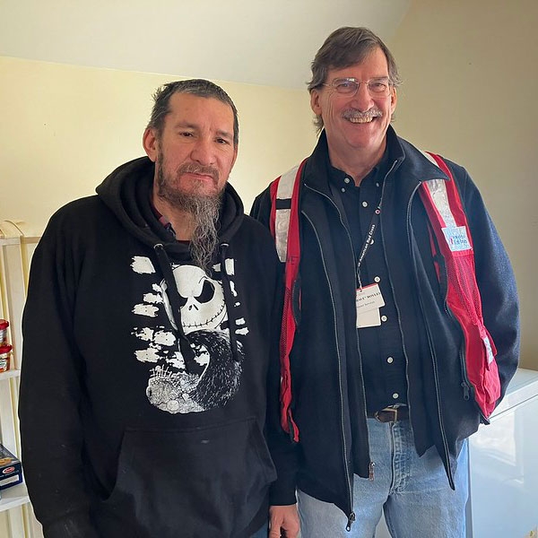 Red Cross volunteer and resident pose for picture