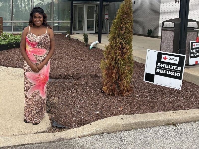 yaya swapsy standing in front of shelter signage