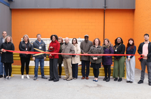 Group of People Cutting Ribbon