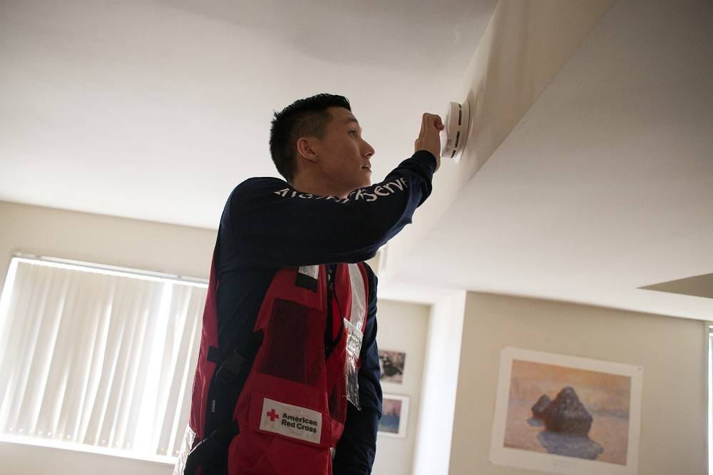 Monday, January 18, 2016. Alexandria, Virginia. 
In honor of Martin Luther King Jr. Day, thousands of volunteers across the country participated in a day of service by canvassing their local communities and installing smoke alarms for their neighbors. The National Capital Region of the American Red Cross hosted MLK Day of Service events supporting the Home Fire Campaign in communities throughout the National Capital Region. Red Cross volunteer, Satoshi Yoshimoto tests a newly installed smoke alarm.
Photo by Dennis Drenner for the American Red Cross