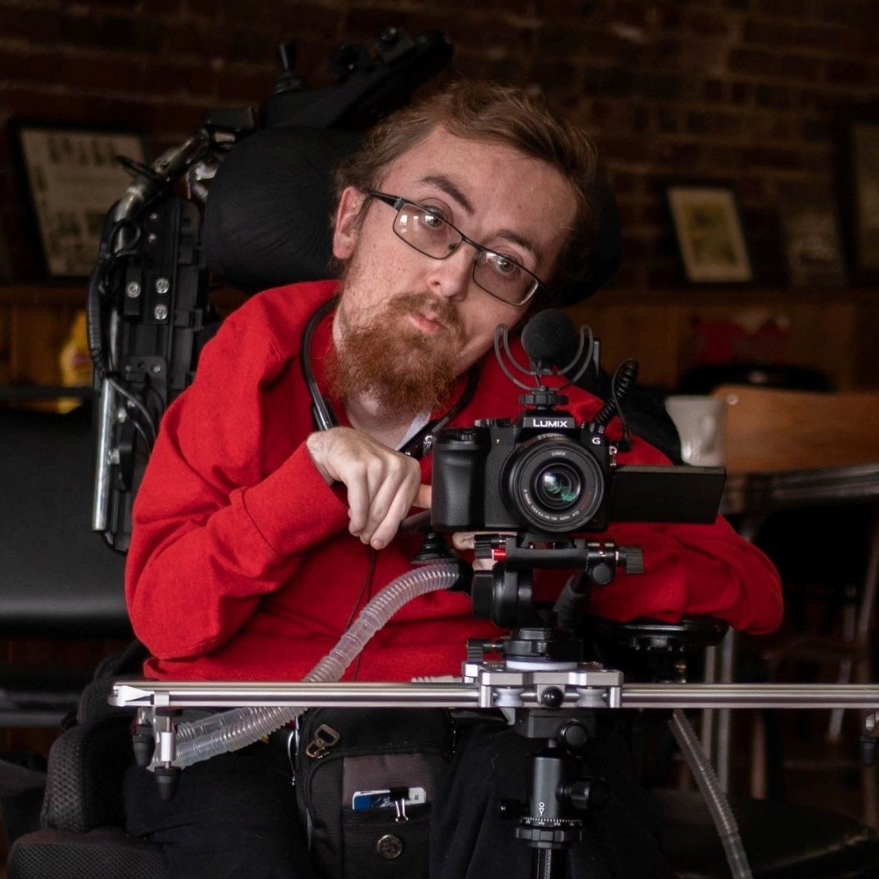 Zach Mecham with his camera photographing an event