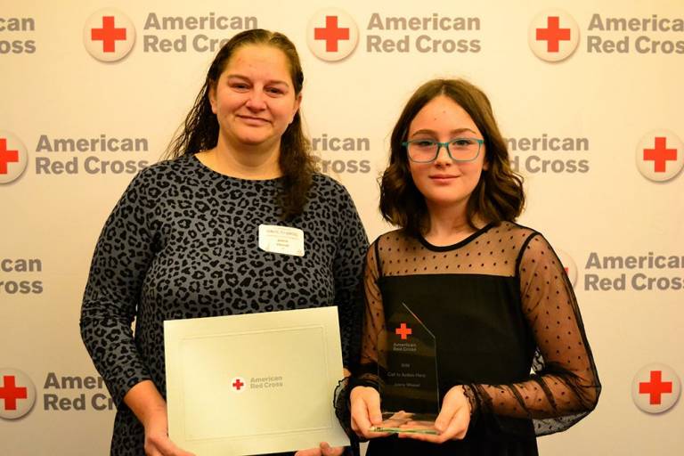 Jolene Wessel and Kaylor Gordine holding Red Cross awards