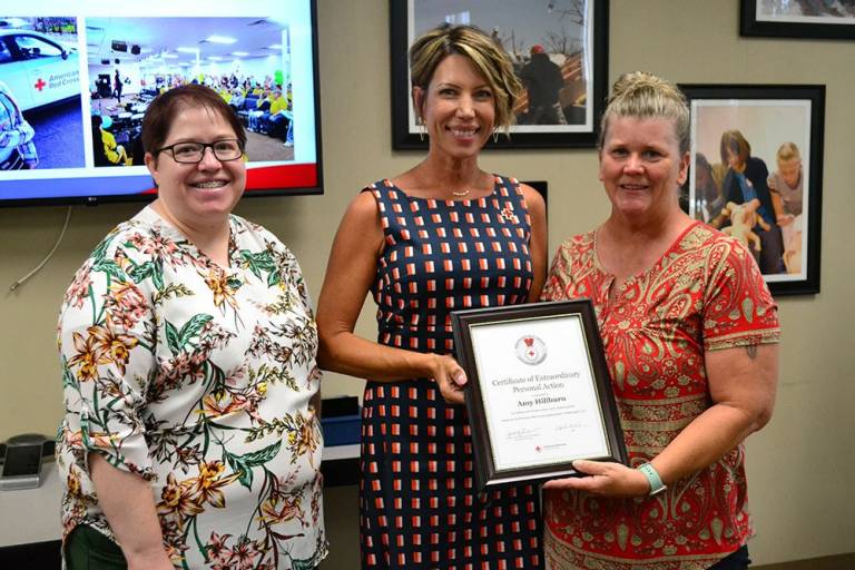 Amy Hillburn receives Lifesaving Award from Kansas-Oklahoma Regional CEO Alice Townsend and Regional Service to the Armed Forces/International Services Director Marama Bayles-Raleigh.
