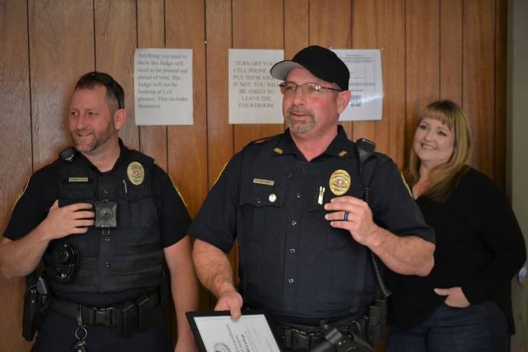 Assistant Police Chief David Bryning holds his Lifesaving Award from the American Red Cross.
