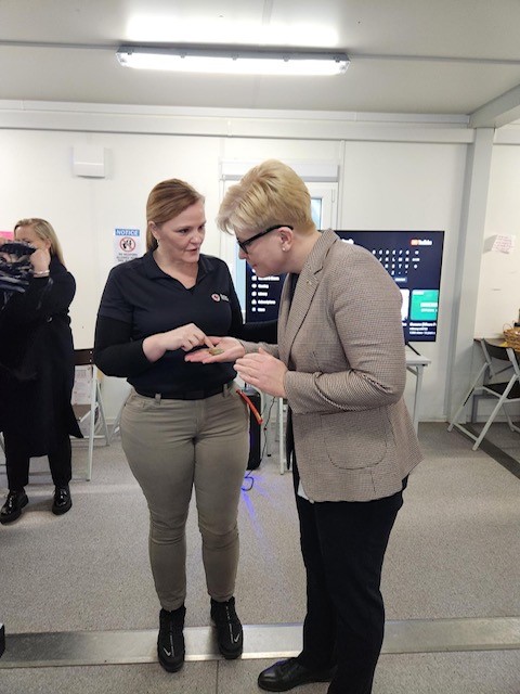 Red Cross SAF Regional Program Manager Amanda English meeting with Lithuanian Prime Minister Ingrida Simonyte. English gave her an American Red Cross coin and briefed her on Red Cross SAF.