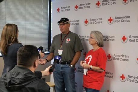 Lori and Patrick Loney talking to media